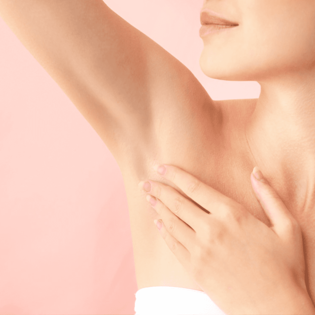 Woman with smooth, hairless armpits after hair removal treatment at Encompass Wellness & Aesthetics.