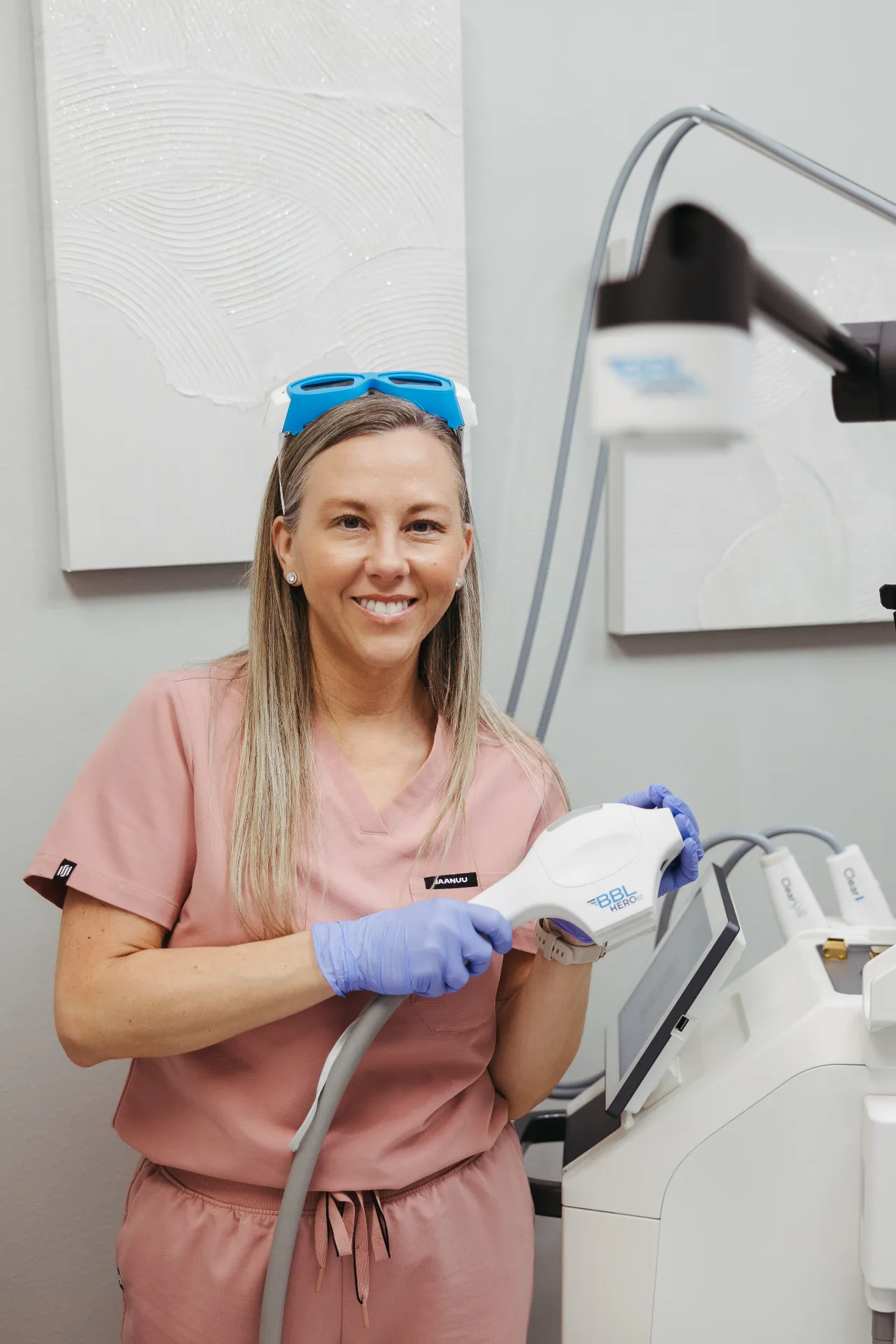 CEO of Encompass Wellness & Aesthetics, Mary Jordan, displaying the BroadBand Light (BBL) Therapy machine.