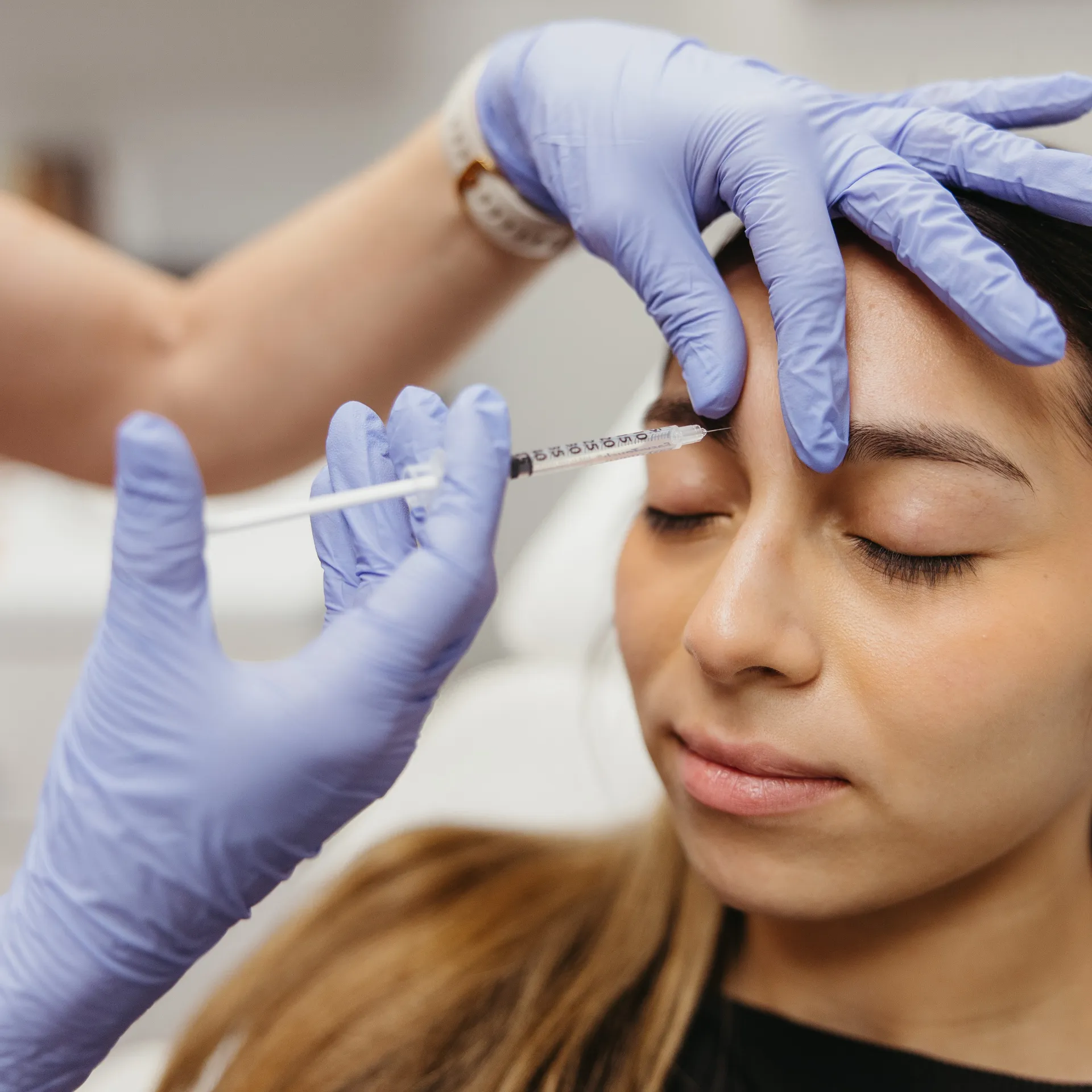 An Encompass Wellness & Aesthetics customer being injected for injectables treatment.