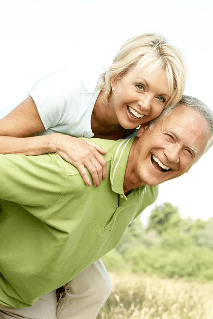 Smiling couple after receiving hormone replacement therapy from Encompass Wellness & Aesthetics.