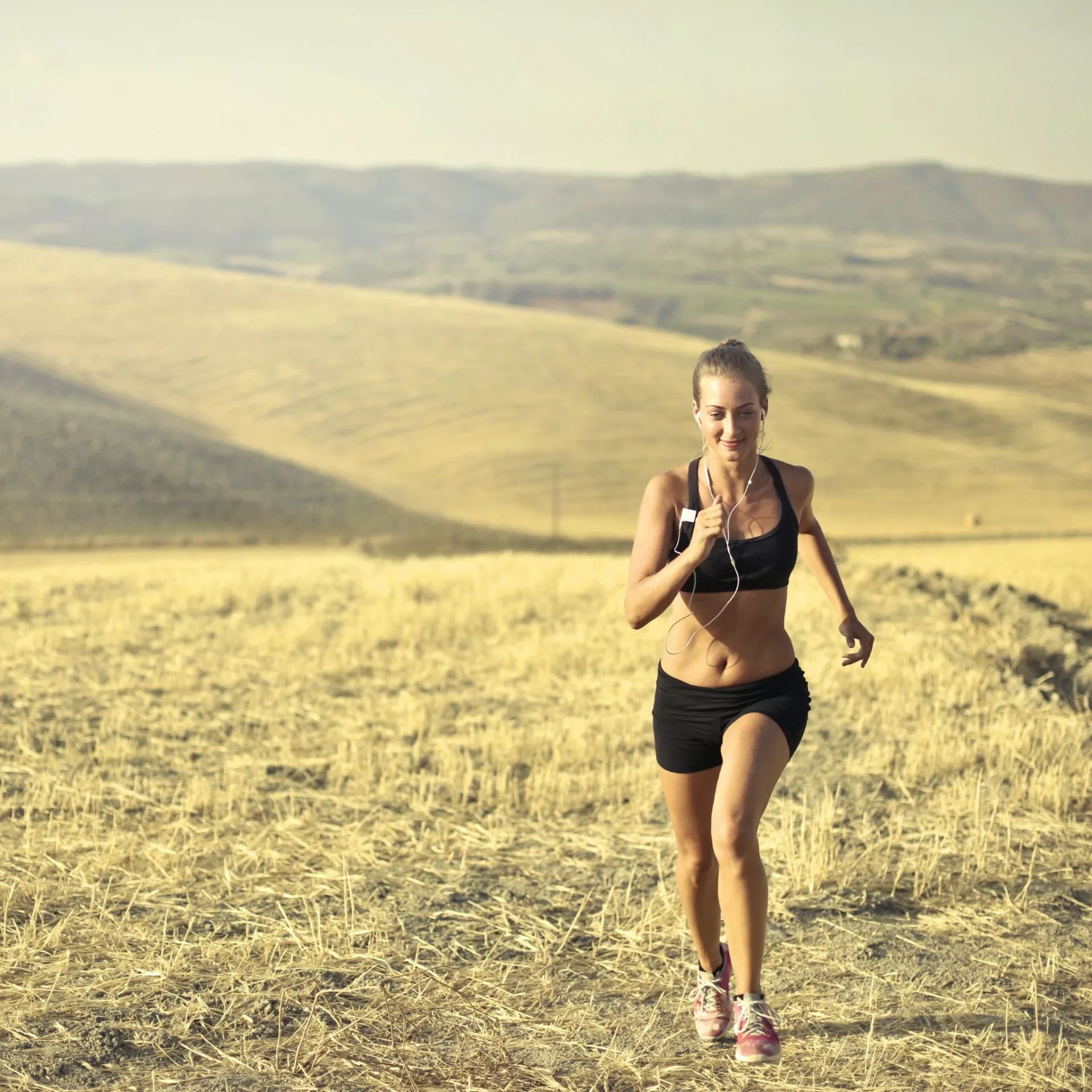 Woman going for a jog in fields after receiving Hormone Cream treatment from Encompass Wellness & Aesthetics.