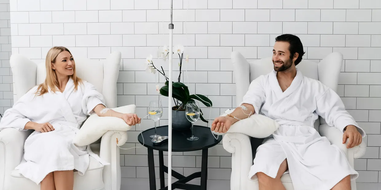 A couple enjoying IV Therapy Services at Encompass Wellness & Aesthetics.