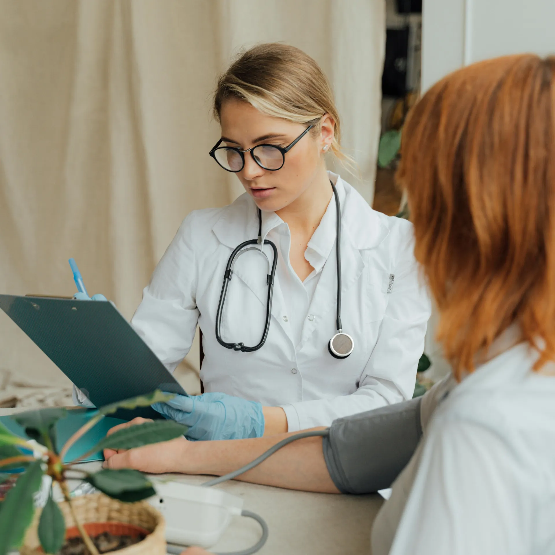 Doctor speaking with adult patient about Early Cancer Screening during a routine clinic visit.