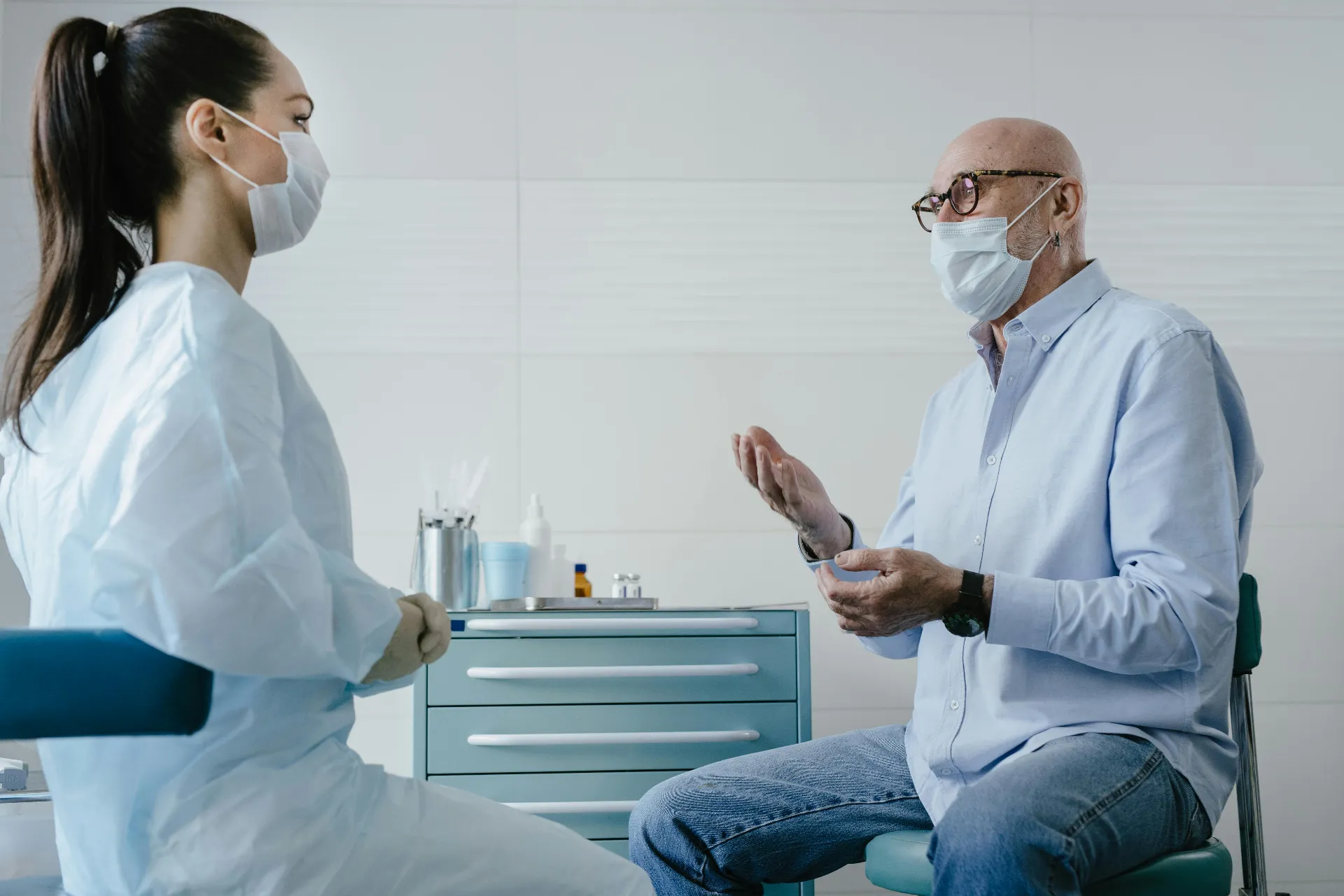 Male patient and provider in a face-to-face medical consultation discussing oral hormone replacement therapy options
